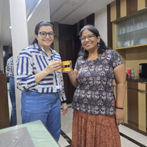Two women holding yellow coffee mugs